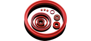 Verschiedene rote Dichtungsringe unterschiedlicher Größen liegen auf einem weißen Hintergrund.